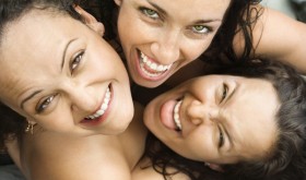 Three women embracing. Three women embracing.